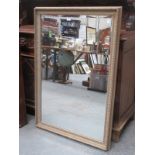 LARGE GILDED AND BEVELLED WALL MIRROR.