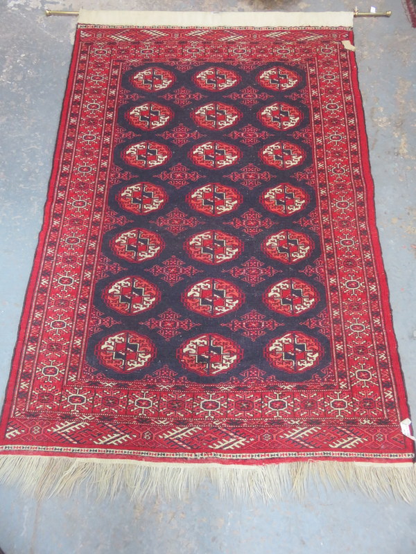 MIDDLE EASTERN STYLE HAND KNOTTED FLOOR RUG, CONVERTED TO WALL HANGING WITH BRASS RAIL,