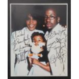 Colour photograph of Whitney Houston & Bobby Brown signed ?To Liza & David The Brown Family Love You