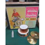 Boxed Swing Along Drum set featuring group on bass drum, with smaller drums, cymbals etc, missing