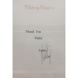 Sheet of paper embossed in gold letters at top Whitney Houston printed Thank You Enjoy Love,