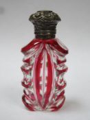 Victorian ruby overlay cut glass scent / perfume bottle, with ornately repousse decorated hinged cap
