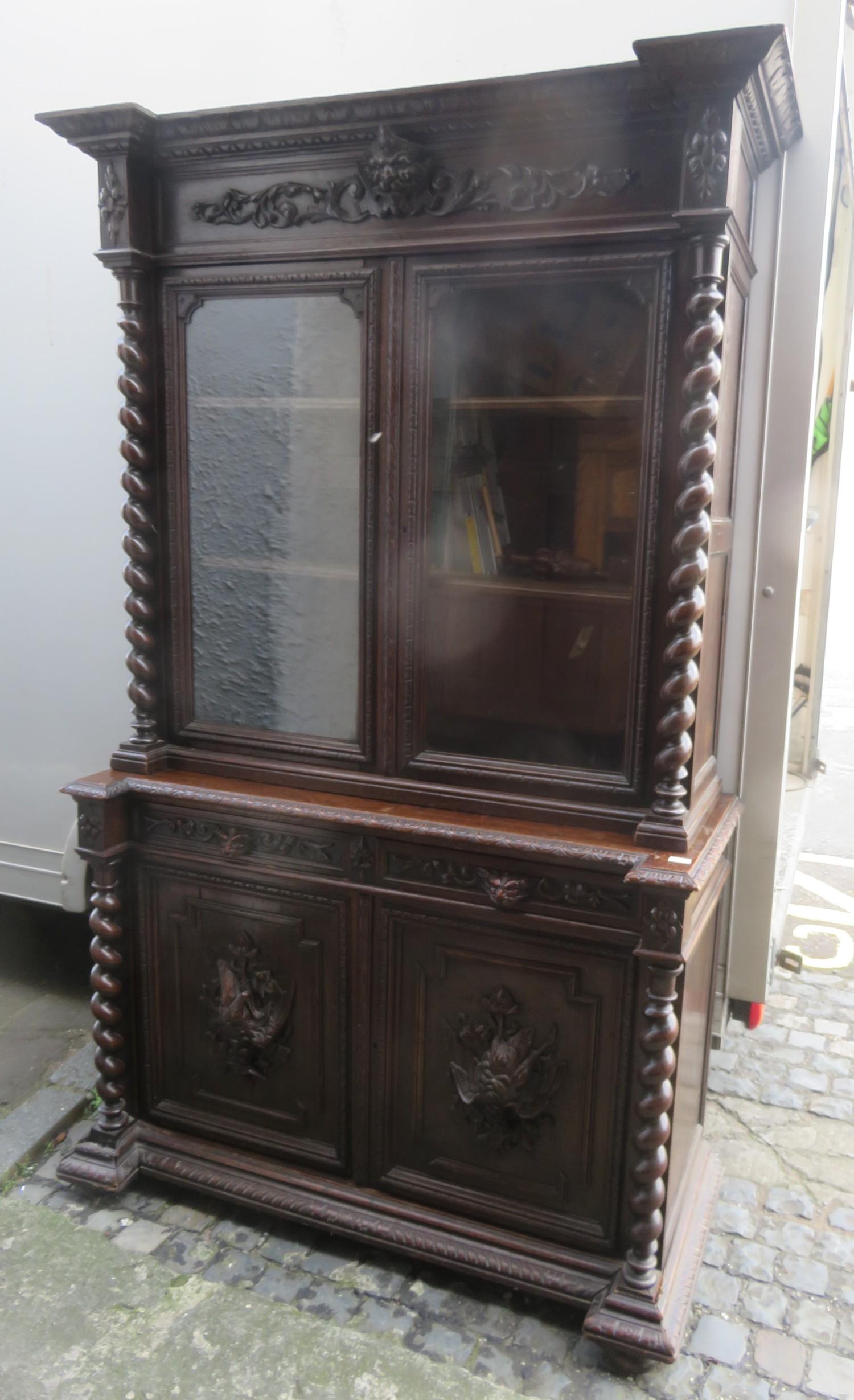 Heavily carved 19th century oak barley twist decocted two door glazed bookcase with cupboard door
