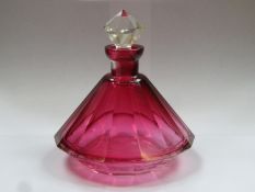 19th century cranberry glass facet cut 14 sided perfume decanter, complete with original stopper.