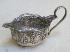 Victorian hallmarked silver cream jug, with repousse fruit and vine decoration, Birmingham assay