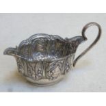 Victorian hallmarked silver cream jug, with repousse fruit and vine decoration, Birmingham assay