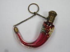 19th century cranberry glass hunting horn shaped scent / perfume bottle, with enamelled foliate