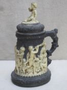 19th century unglazed black basalt style lidded pottery tankard, relief decorated in the Wedgwood