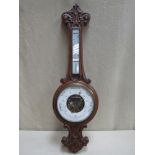 Victorian carved oak cased aneroid banjo barometer, with enamelled skeleton dial and mounted