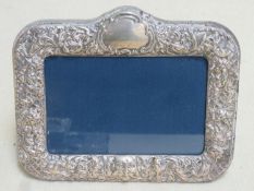 Hallmarked silver repousse decorated free standing photo frame by Carr's, Sheffield assay dated 1992