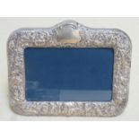 Hallmarked silver repousse decorated free standing photo frame by Carr's, Sheffield assay dated 1992