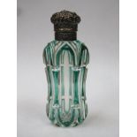 Victorian green overlay cut glass scent bottle, with ornately repousse decorated hinged cap, cap