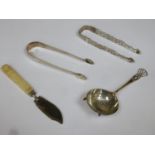Two pairs of hallmarked silver sugar tongs, hallmarked silver tea strainer, plus hallmarked silver