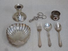 Mixed lot of silver including candle stand, sugar tongs, shell form receiver, enamelled napkin ring,