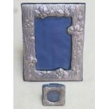 Hallmarked silver repousse decorated free standing photo frame, plus a smaller circular hallmarked