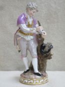 19th century Meissen hand painted and gilded ceramic figure depicting a young gent collecting