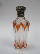 Victorian orange overlay cut glass scent / perfume bottle, with ornately repousse decorated hinged