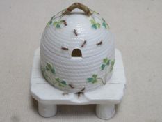 First period Belleek grass pattern honey pot and cover in the form of a wicker bee skep, raised on