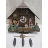 Vintage carved wooden cased cuckoo clock with automation, modelled on a European thatched chalet,