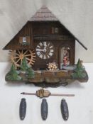 Vintage carved wooden cased cuckoo clock with automation, modelled on a European thatched chalet,