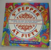 Sgt. Pepper At Fifty signed by author Mike McInnerney and Dudley Edwards who painted Paul