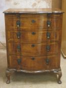Early 20th century mhaogany and walnut veneered serpentine fronted chest of four drawers, with
