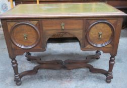 Early 20th century oak leather topped writing desk, fitted with three drawers, on stretchered