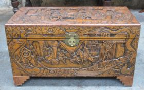 Heavily carved early to mid 20th century camphorwood storage chest, decorated with oriental