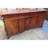 19th century mahogany four door, four drawer, with heavily carved decoration, on raised claw