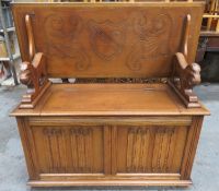 20th century oak linen fold fronted monks bench, with lift up seat, fold down back, and lion form
