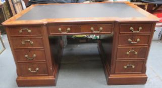 20th century walnut veneered partners desk, on pedestal supports, fitted with ten drawers and two