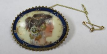 Victorian gilt metal oval brooch with mounted handpainted porcelain panel depicting a female side