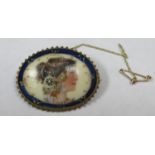 Victorian gilt metal oval brooch with mounted handpainted porcelain panel depicting a female side