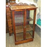 19th century walnut two door glazed display cabinet with inlaid and pierce work decoration.