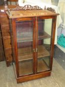 19th century walnut two door glazed display cabinet with inlaid and pierce work decoration.