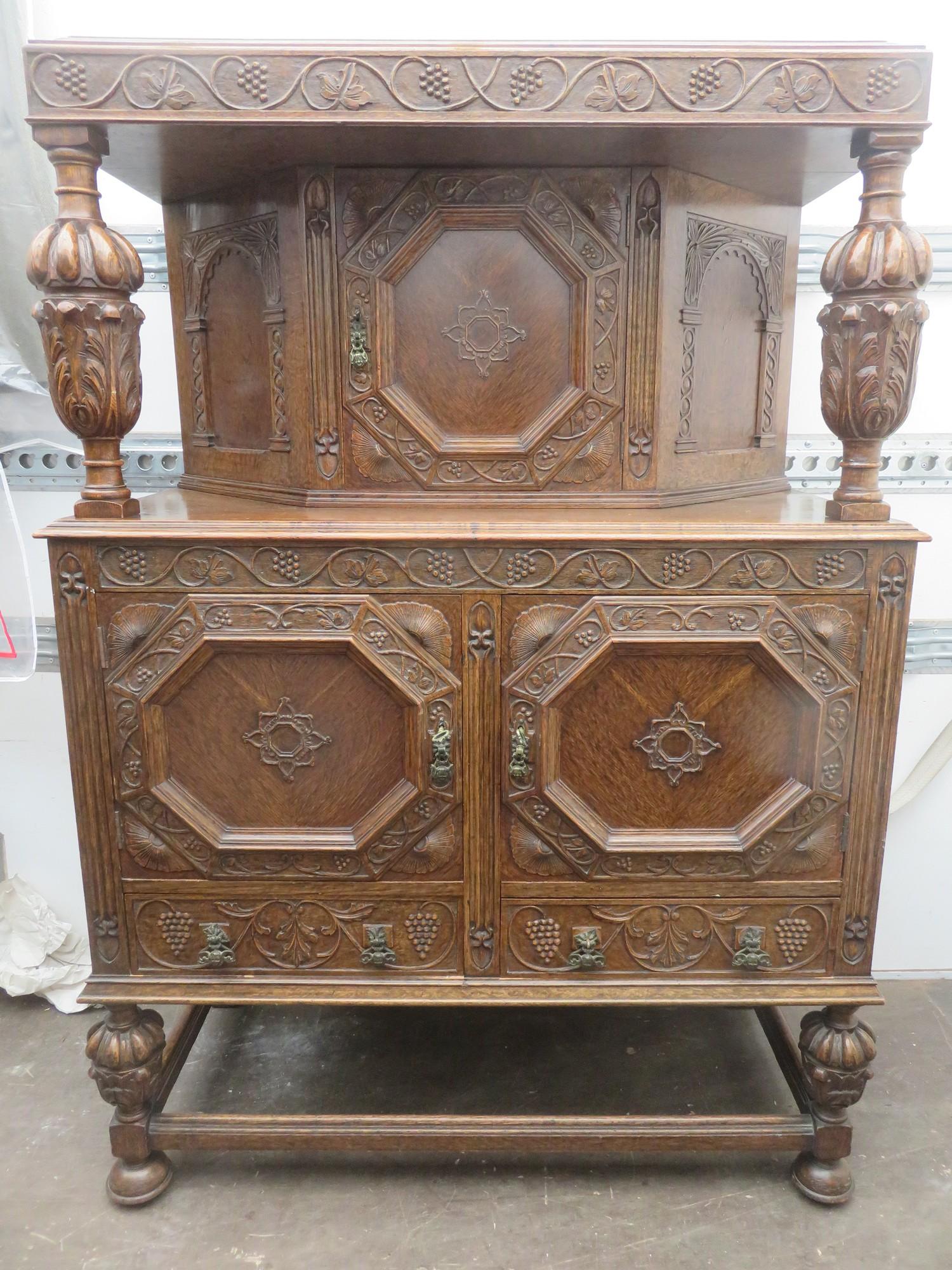 Early 20th century heavily carved oak court cupboard on pineapple supports. Approx. 152 widhigh x