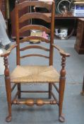 19th century rush seated country style ladder back armchair, on stretchered supports. Approx.