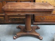 Victorian mahogany fold over games table, on quadrafoil supports, with felt lined interior.