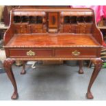 20th century mahogany writing desk, fitted with drawers, pigeon holes and central small cupboard, on