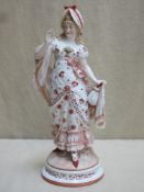 German hand painted and gilded figure depicting a lady in period clothing, stamped KPM to base and