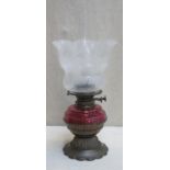 Victorian brass piercework decorated shallow oil lamp, with cranberry glass reservoir and floral