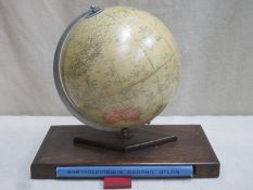 George Phillips 10 inch challenge globe on oak supports with insert containing atlas . Approx.