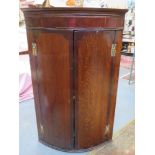 19th century oak and mahogany bow fronted wall mounted corner cupboard. Approx. 104cm H x 67cm W x