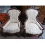 Pair of Victorian mahogany framed upholstered easy chairs, with carved decoration