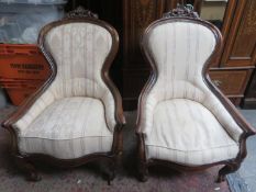 Pair of Victorian mahogany framed upholstered easy chairs, with carved decoration