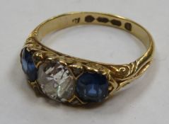 18ct gold ladies dress ring set with central diamond, flanked by two blue sapphires