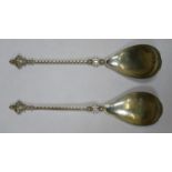 Pair of 830 silver presentation spoons, with twist decorated handles and goddess style finials.