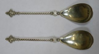 Pair of 830 silver presentation spoons, with twist decorated handles and goddess style finials.