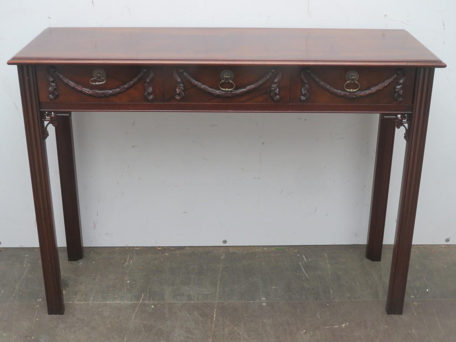 20th century mahogany three drawer console table with carved decoration to front, Approx. 75.5cms