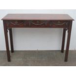 20th century mahogany three drawer console table with carved decoration to front, Approx. 75.5cms